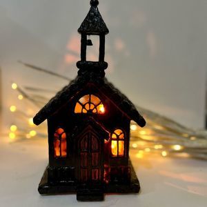 HAND PAINTED CERAMIC HOUSE WITH ORANGE STRING LIGHTS